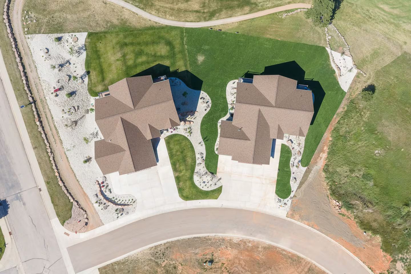 Overhead aerial of both homes beside the golf course