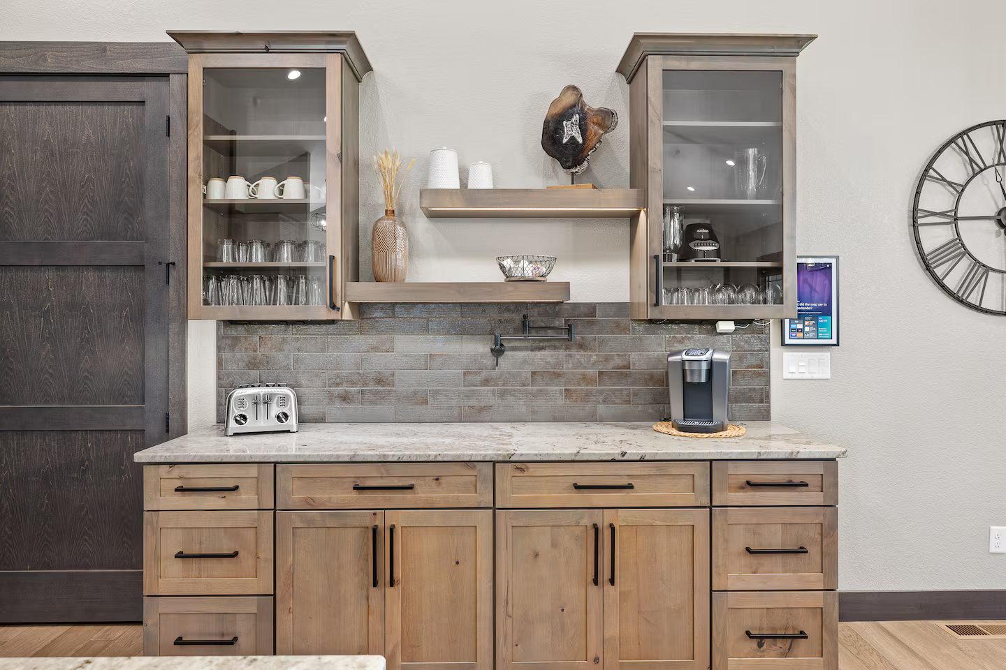 Coffee bar with a Keurig, open shelves and glass-front cabinets