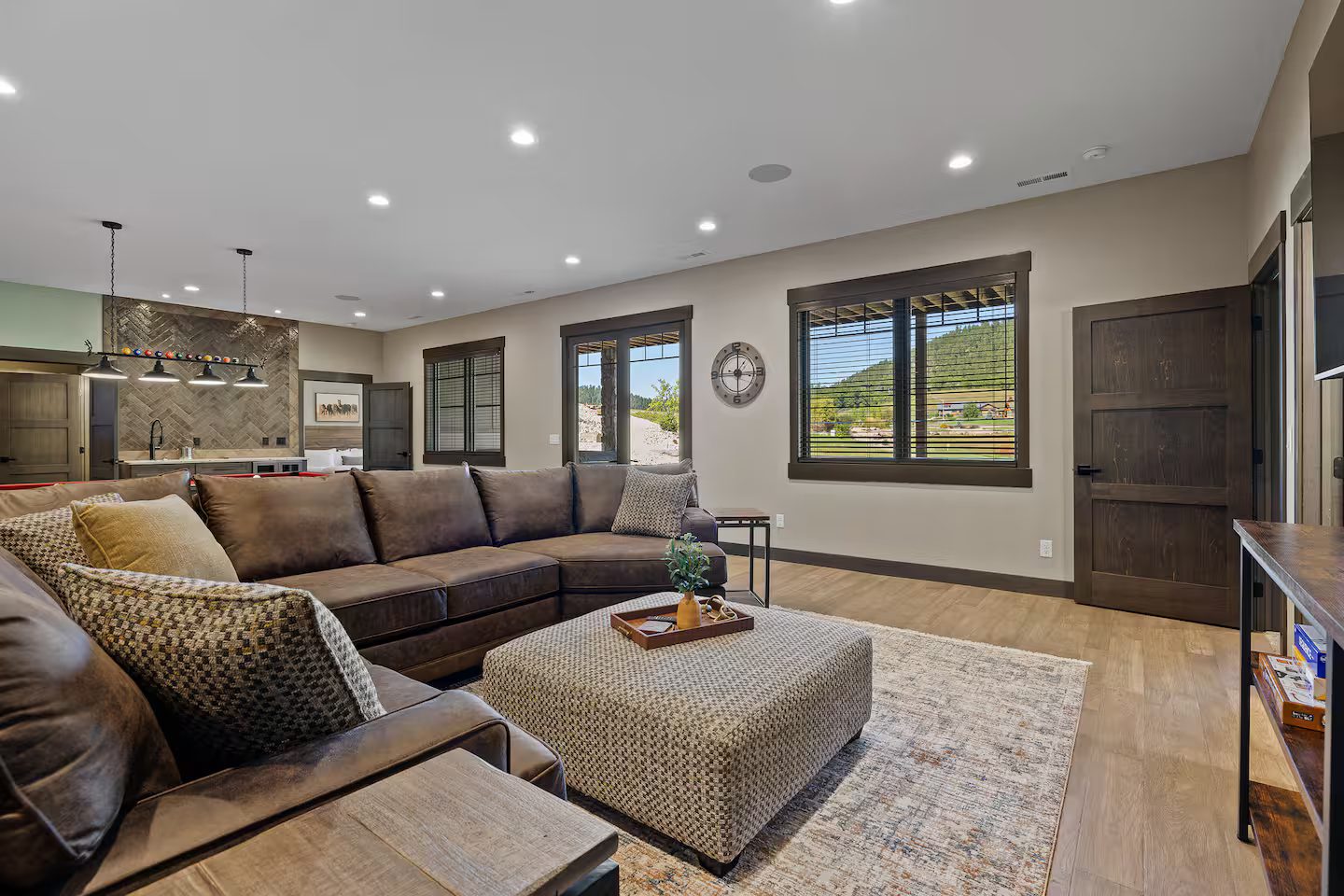 Downstairs family room with a large sectional and an ottoman